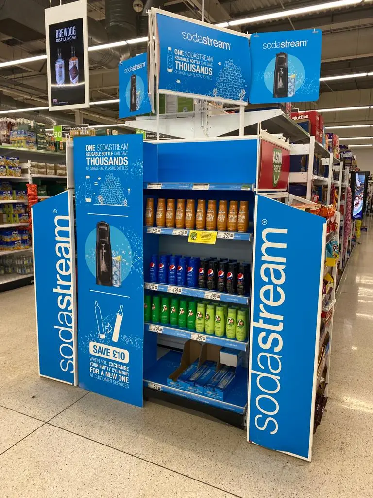 Bright blue stand showcasing SodaStream CO2 cylinders with saving offer