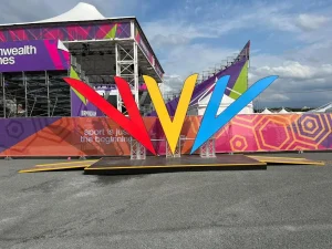 Large Commonwealth Games logo display with event branding in the background