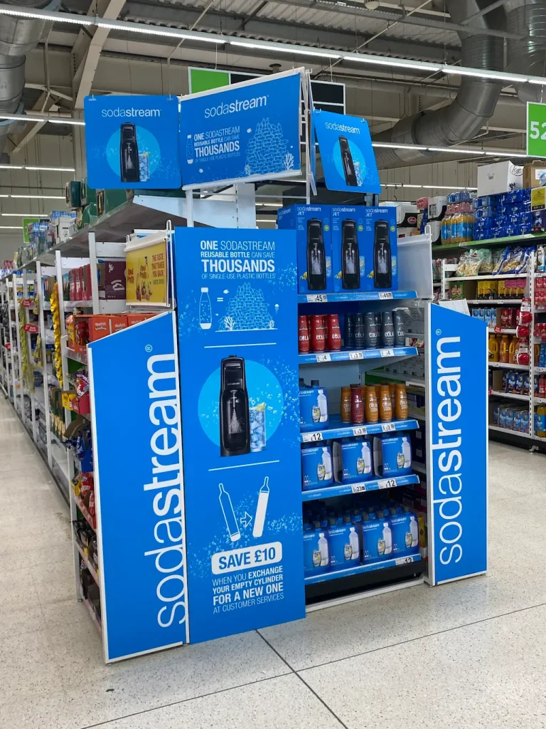 Blue branded display with product bundles and eco-saving graphics